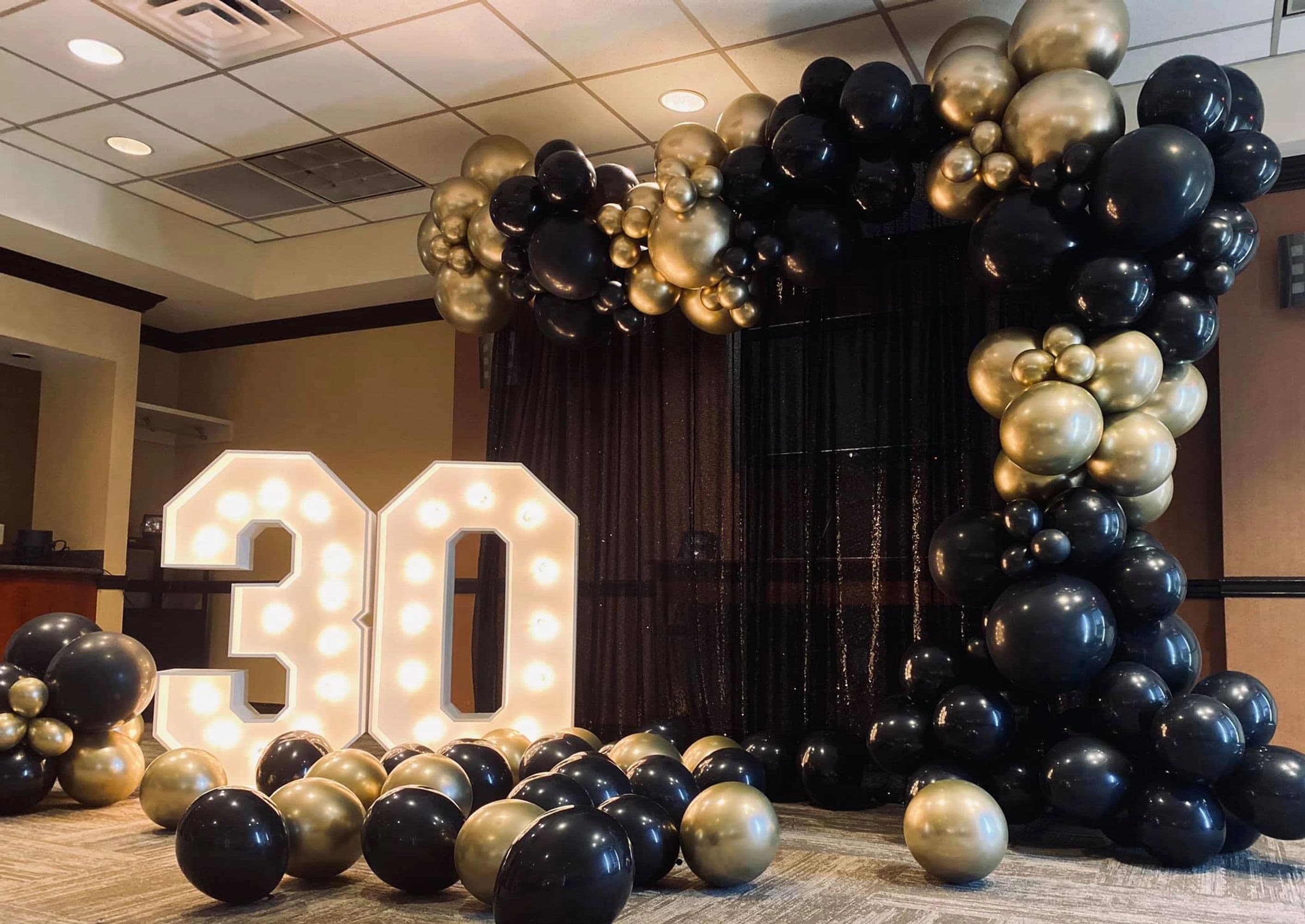 30th birthday marquee with balloon garland