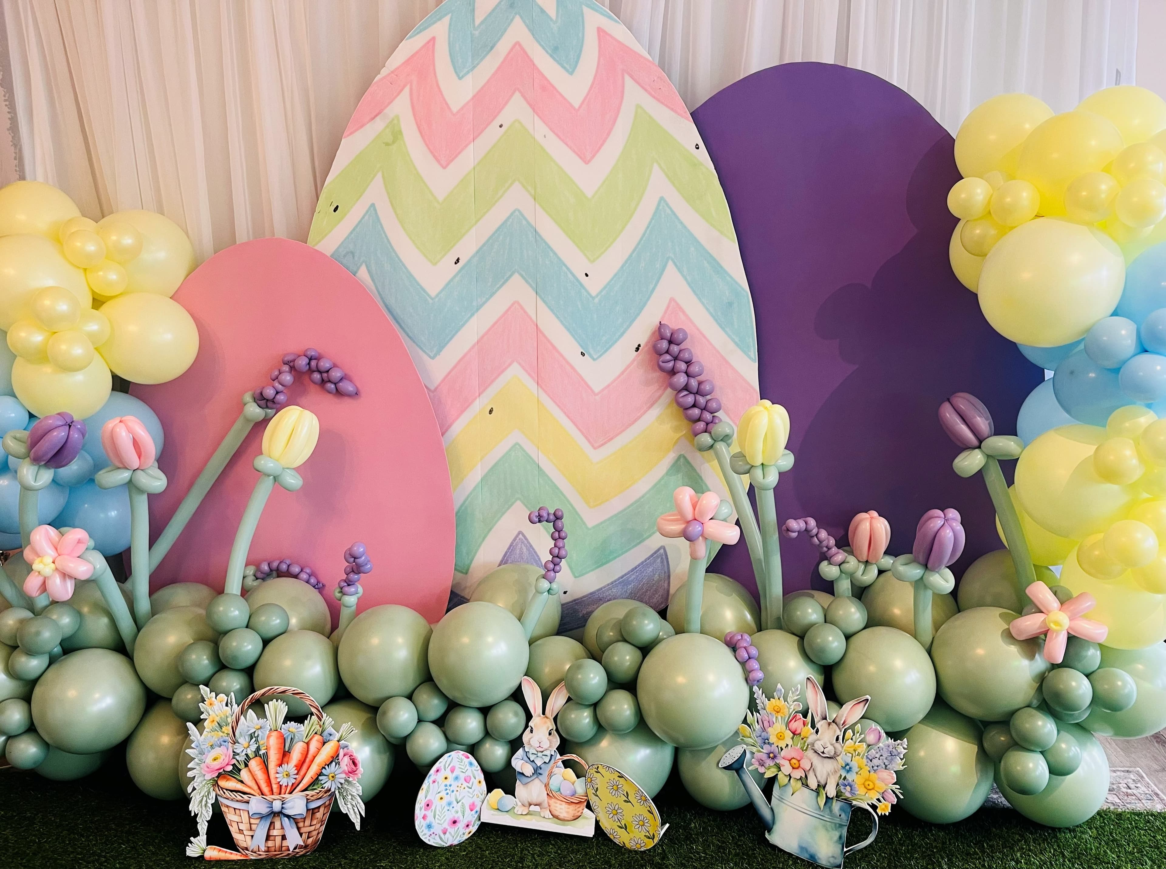 Pastel Easter egg backdrop with balloon flower garden