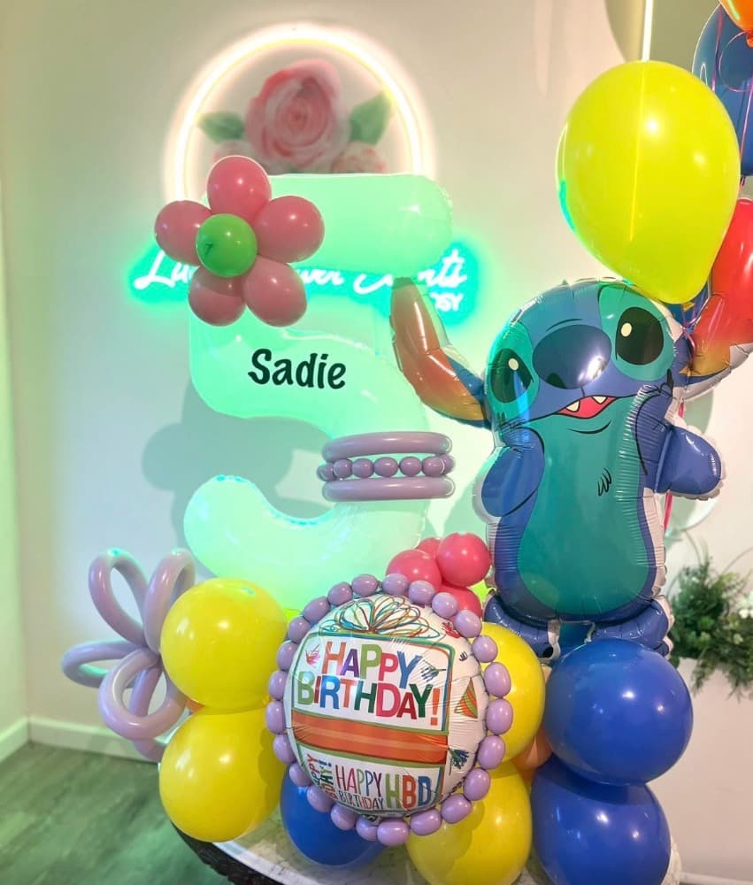 Stitch-themed 5th birthday balloon column with neon number